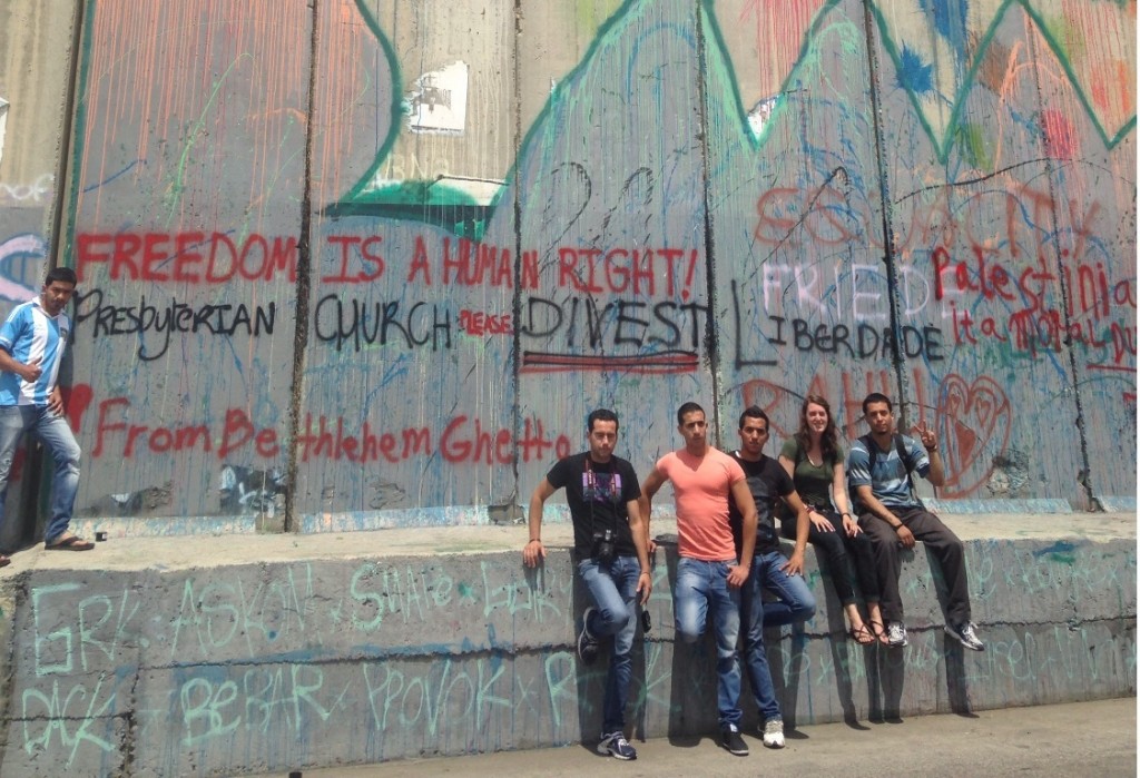 Young residents of Bethlehem at the Separation Wall with grafitti message to Presbyterian Church days before the General Assembly vote in Detroit.